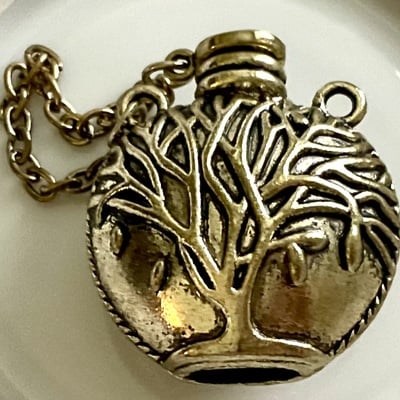 Brass-plated world tree flask pendant